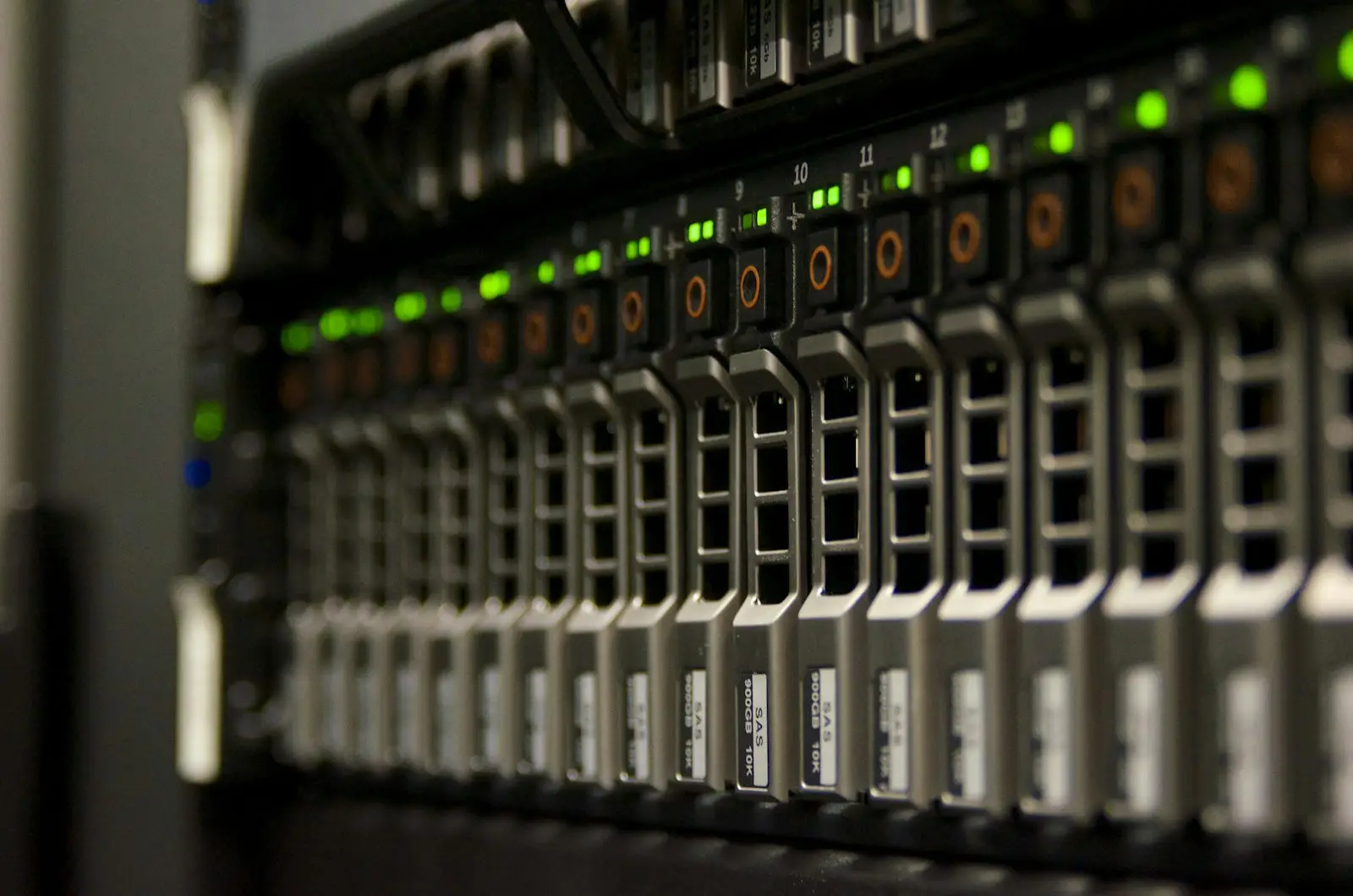 A server drive bay with rows of green and amber status lights.