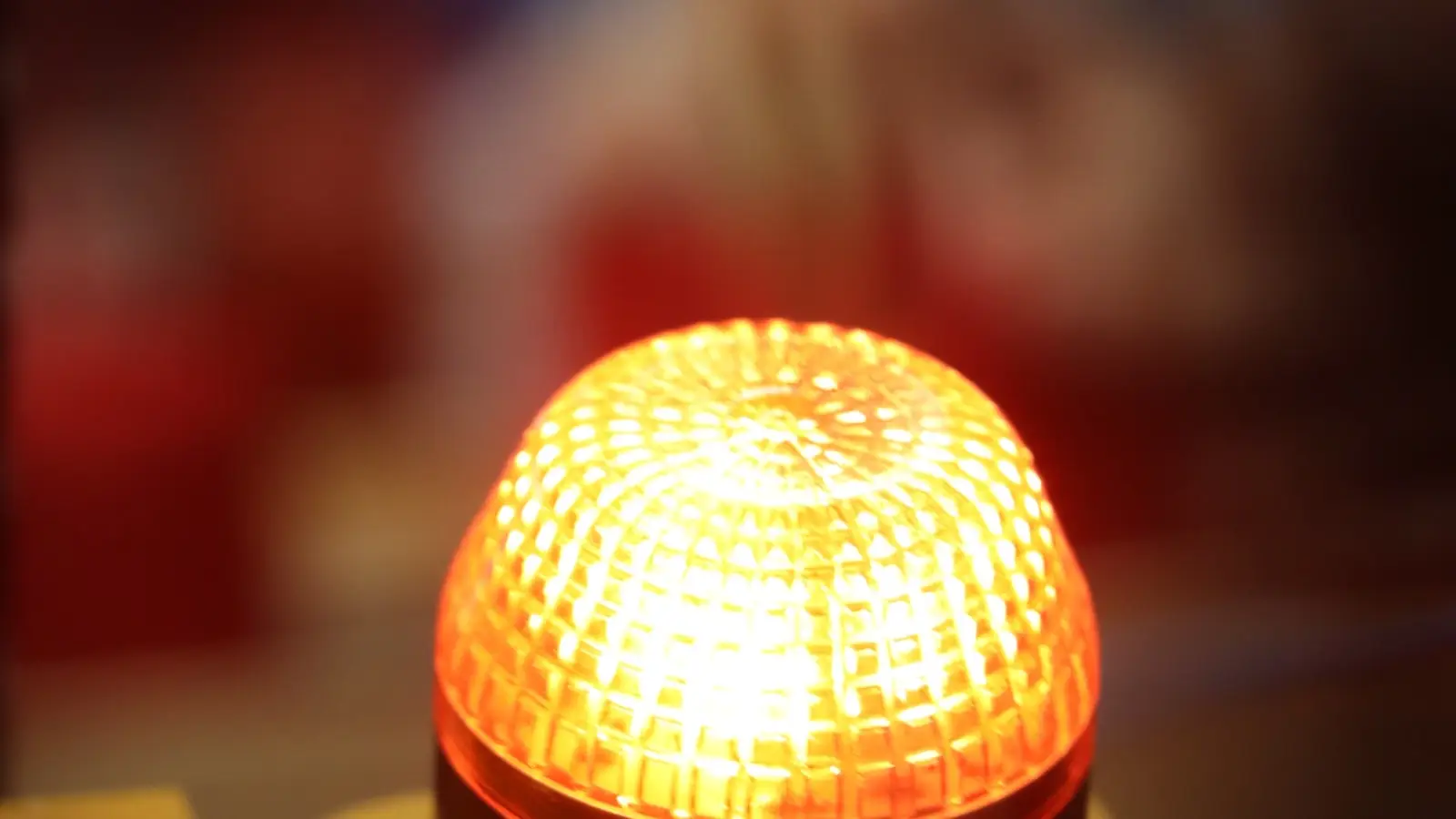 An amber beacon light glowing on a machine.