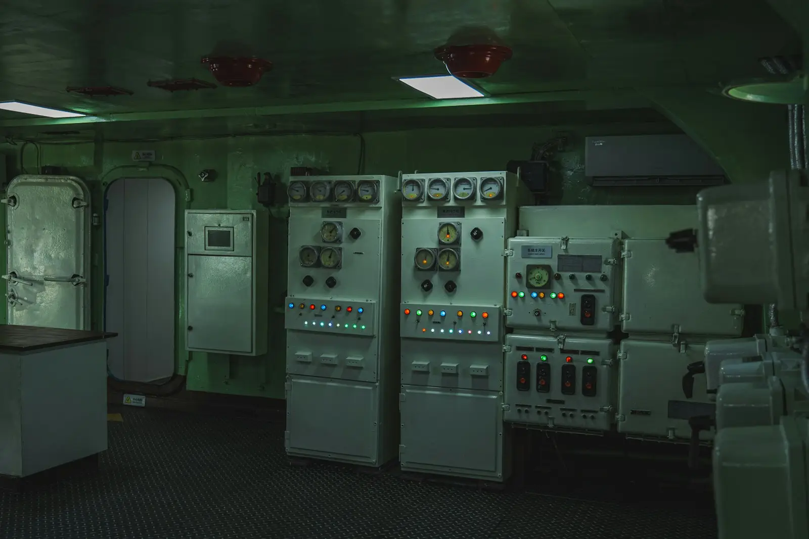 Electrical control cabinets with dial gauges and indicator lights in an equipment room
