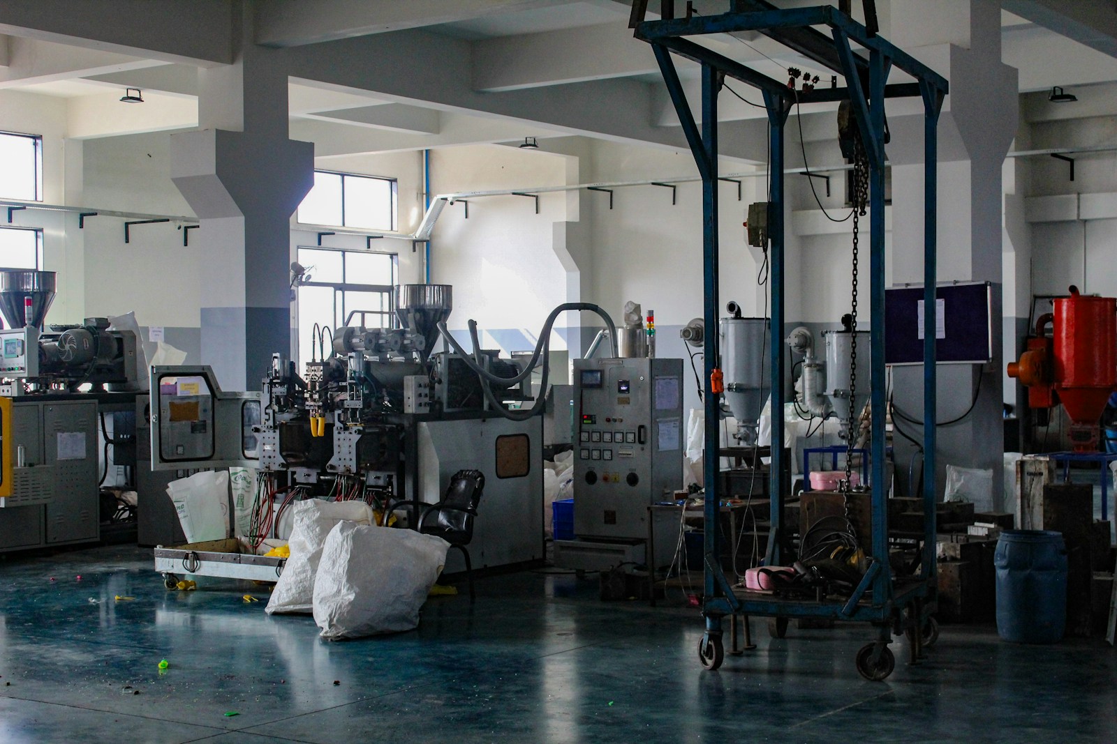 Molded plastic parts leaving an injection molding machine